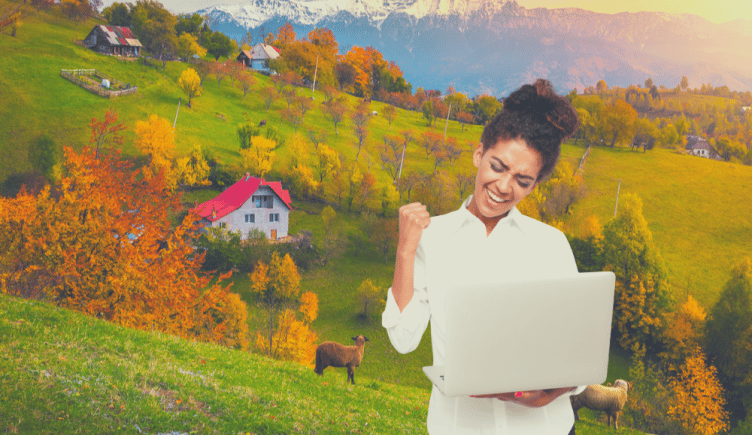 developer with laptop, hillside in the background