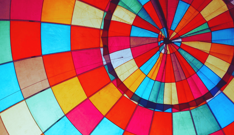 The multicolored patches of a hot air ballon fit perfectly to help propel the ballon higher.