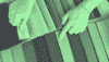 A green-toned image of two hands selecting fabric samples. what-is-data-fabric